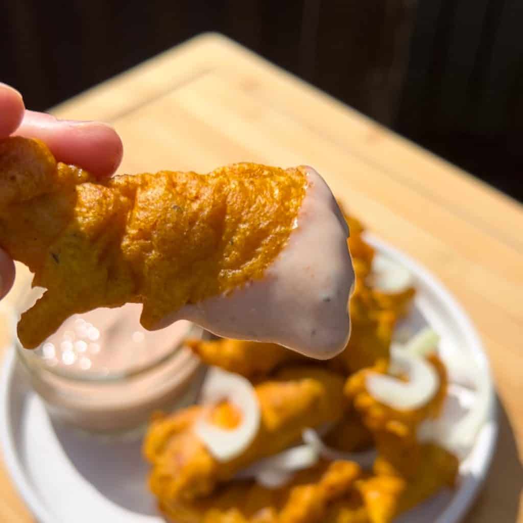 chicken pakora dipped into pink sauce