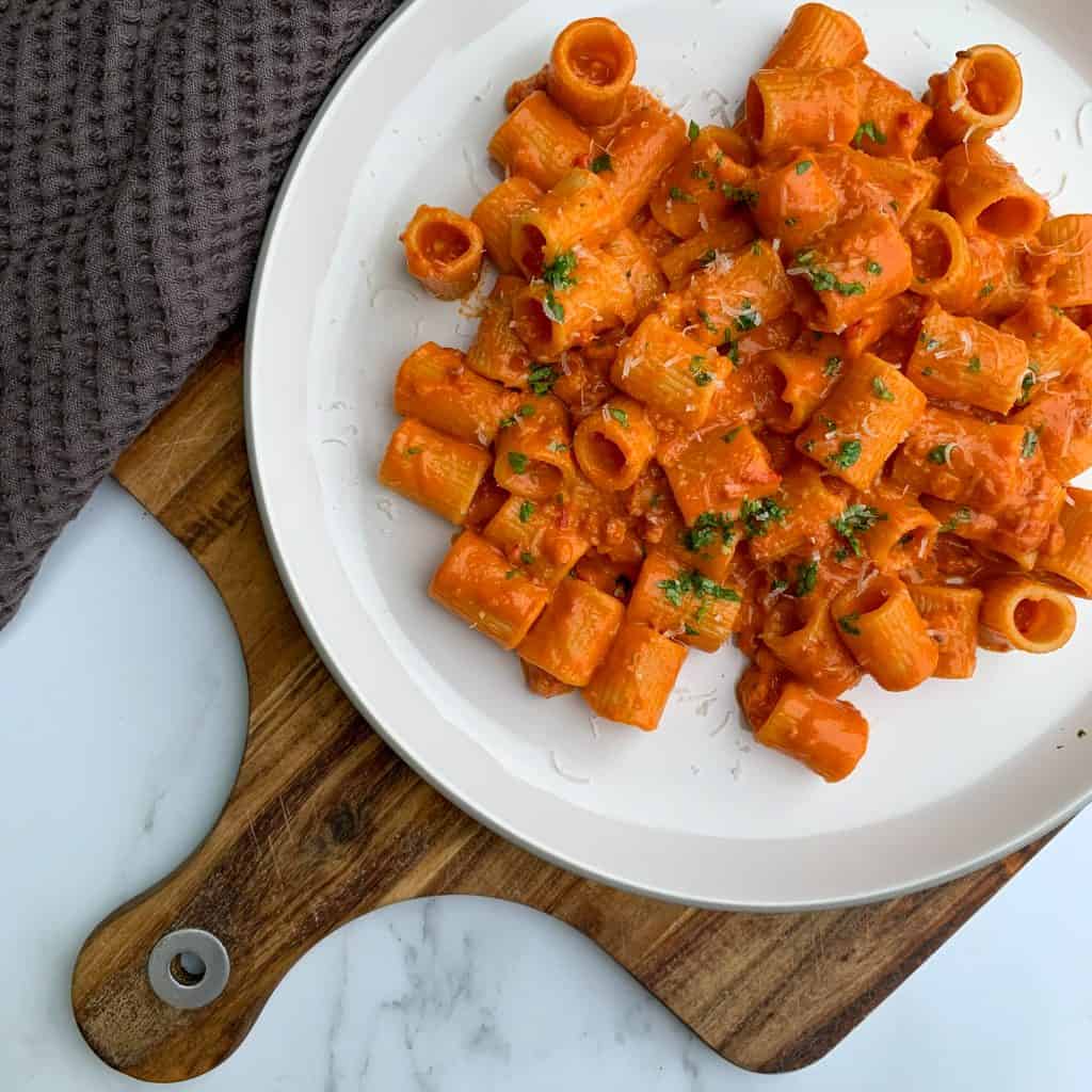 prosecco pasta with Italian sausage on a plate garnished with parsley