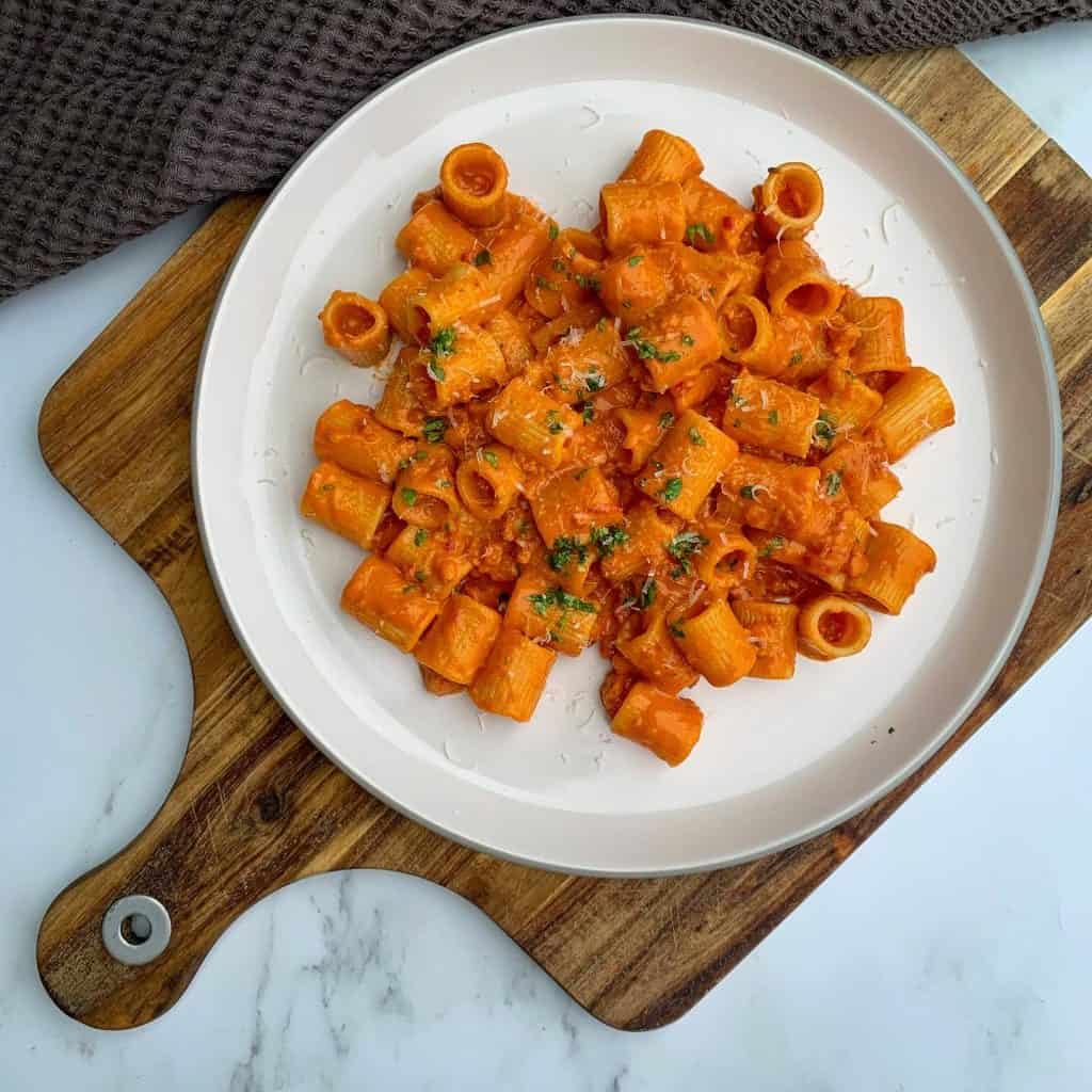 prosecco pasta with Italian sausage on a plate garnished with parsley