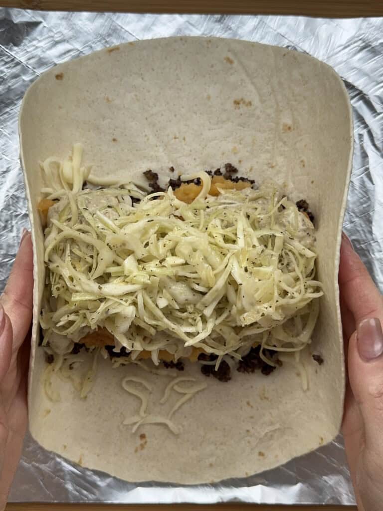 A person holding a taco.