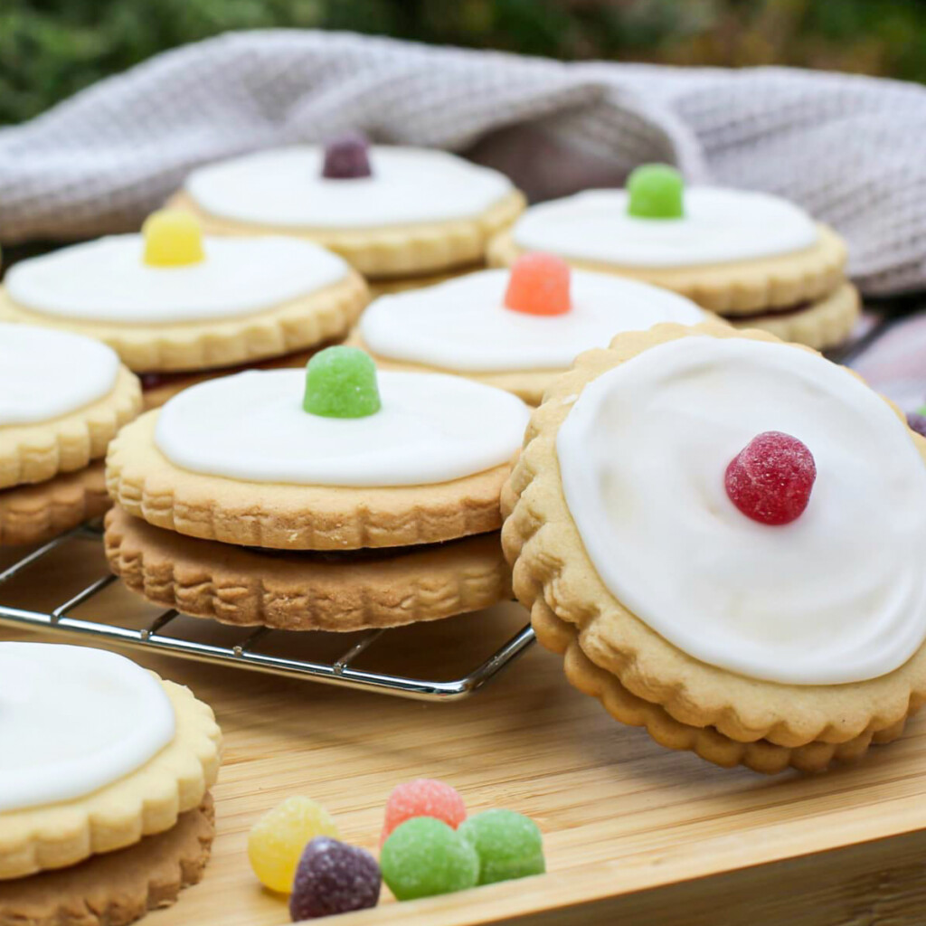 Delicious empire biscuits with white icing and colourful jelly tots, perfect for baking and treats.
